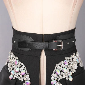 Detail of black corset belt featuring colorful rhinestones and silver metal buckle