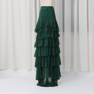Detail of multi-layered ruffle design and hidden back zipper on dark green maxi skirt