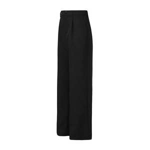 Detail of black high-waisted wide-leg trousers with front pleats and draped fabric