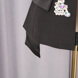 Detailed macro view of shimmering rhinestones and colorful sequins on a black mini skirt