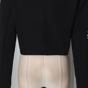 Detail view of the slim-fit back waist on this black blazer with sequin sleeve accents