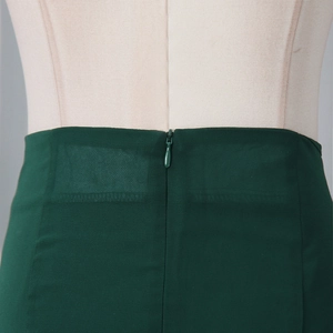 Detail of invisible back zipper and stitching on the dark green ruffle mini skirt