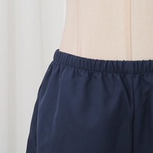 Detail of navy blue high-waisted elastic waistband on stylish two-piece women's shorts