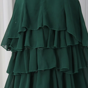 Detail shot of multi-layered dark green ruffle chiffon skirt with fine stitching