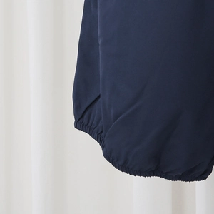 Detailed close-up of dark blue elastic cuffs with premium stitching on a fashion set