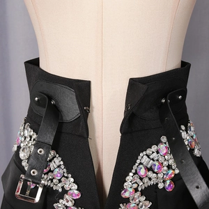Detailed view of black high waist band with luxury rhinestone embellishments and buckle