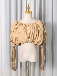 Short beige puff sleeve blouse with adjustable cuff ties and a round neckline
