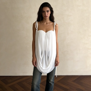 Detail of white pleated camisole top with adjustable shoulder straps and heart neckline