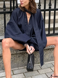 Navy blue oversized long sleeve blouse with puff sleeves and tie-up deep V-neckline