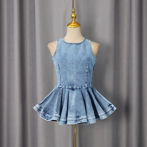 Close-up of light blue denim sleeveless top with peplum hem and tailored round neck detail