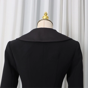 Detail view of the wide lapels and structured back seam on this black blazer