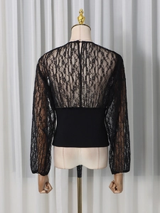 Back view of a black lace long sleeve top featuring slim fit waist and floral mesh