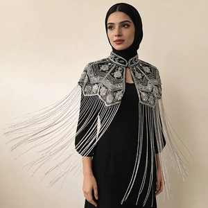 Detail of black shawl with silver bead embroidery and long metallic tassel fringe