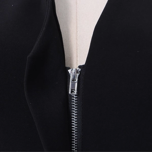 Close-up of a high-quality silver metal zipper on a black structured blazer jacket