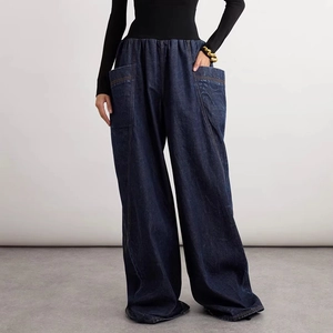 Detail of dark blue wide-leg cargo jeans featuring oversized side pockets and high waist
