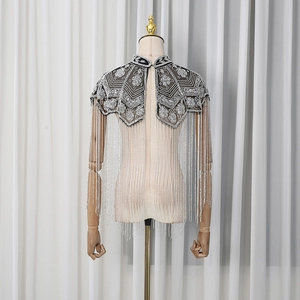 Detail of floral beaded shawl with long silver fringe tassels and mesh sequins