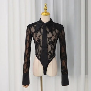 Close-up of black lace bodysuit featuring floral patterns, shirt collar and tie detail