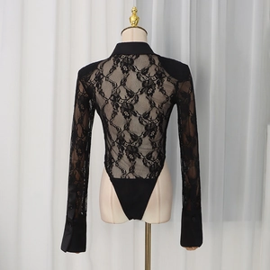 Detail of black long-sleeve bodysuit featuring floral lace and a classic shirt collar