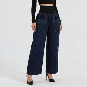 Close-up of wide black elastic high waistband and contrast stitching on blue denim pants