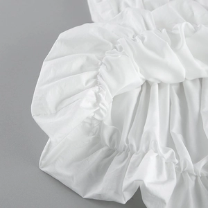 Gros plan détaillé du tissu blanc à volants avec design plissé et plis de tissu doux