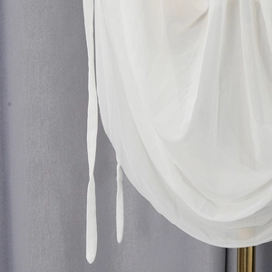 Detail of white mesh fabric with elegant pleated texture and side drawstring ties