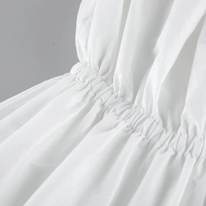 Détail de la couture froncée élastique et des finitions soignées sur le top blanc