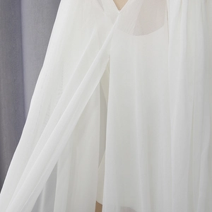 Macro detail of high-density white mesh fabric with elegant pleated textures and V-cut design