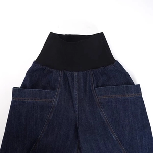 Detail of high waist wide leg jeans with elastic waistband and large front pockets