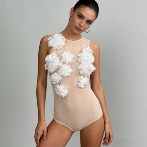 Close-up of nude mesh bodysuit featuring 3D white organza flower appliques for women
