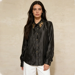 Detail of sequined pointed collar on a black satin long sleeve shirt for women