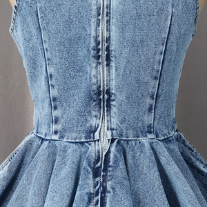 Detail view of the back zipper and pleated waist design on this blue denim sleeveless top