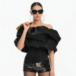 Detailed close-up of a black off-shoulder corseted top with premium satin finish