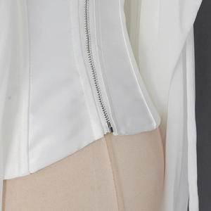 Detail of white satin camisole with metal zipper and breathable mesh stitching