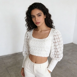 Detail of white lace texture and puff sleeves on this French style cropped blouse
