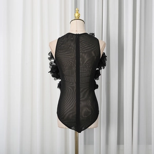 Detail of sheer black mesh bodysuit with 3D floral appliques and back zipper closure
