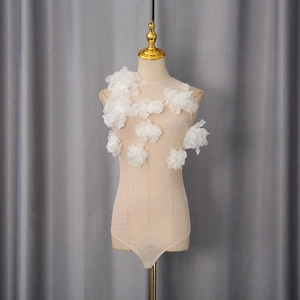 Close-up of 3D floral appliques on mesh bodysuit for a sheer layered look