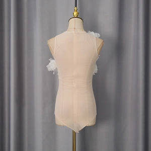 Detailed view of 3D white floral patches on mesh bodysuit with back zipper closure