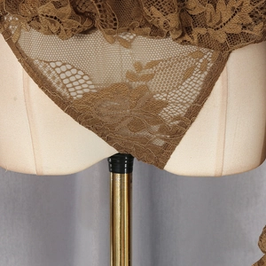 Gros plan sur la dentelle florale d'un body marron sexy avec des détails transparents
