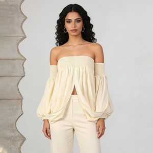 Detail of smocked off-shoulder top with puff sleeves and matching wide-leg trousers