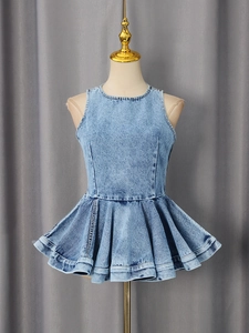 Blue denim sleeveless peplum top with round neck and detailed stitching on a dress form