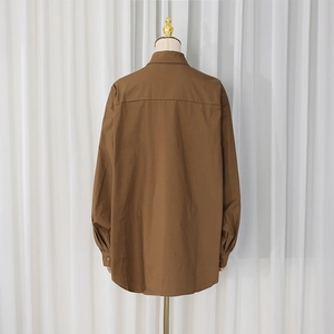 Rear view detail of brown oversized cotton shirt with drop shoulder and back yoke seam