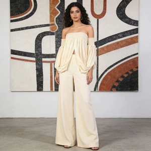 Chic cream off-shoulder top with voluminous puff sleeves and high-waisted wide-leg trousers