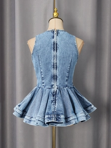 Light blue denim sleeveless peplum top featuring a long metal zipper back on a mannequin