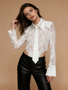 White long sleeve lace bodysuit with satin tie and collar paired with black leather pants