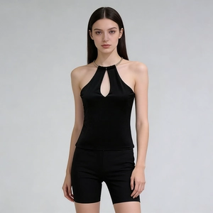 Close-up of black halter top featuring a gold metal ring and teardrop cutout detail
