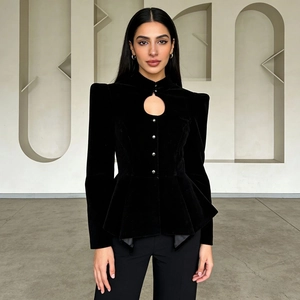 Detailed view of the velvet fabric and silver buttons on the black peplum blazer jacket
