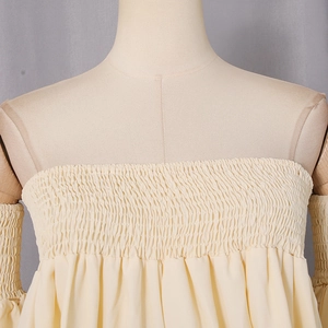 Close-up of beige smocked tube top with elastic texture and ruffled sleeve details