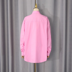 Back view of pink oversized long-sleeve shirt showing yoke detail and loose cut