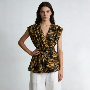 Detailed shot of V-neck top featuring abstract print and golden metal ring belt detail