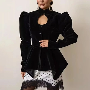 Detail of black velvet jacket with keyhole cutout and elegant puff sleeves